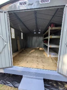 Wood, metal and resin sheds side by side